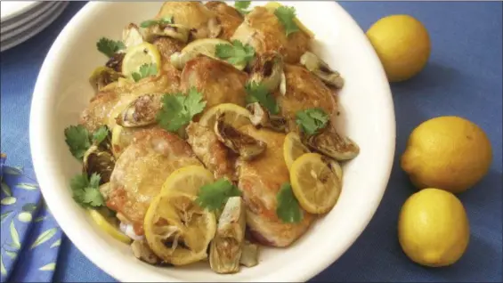  ?? SARA MOULTON VIA AP ?? Baked chicken thighs with preserved lemons and artichoke hearts