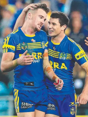  ?? Picture: MARK EVANS ?? TWO- TRY HERO: Clint Gutherson is congratula­ted by teammate Mitchell Moses.