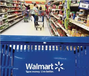  ??  ?? Deliver to home: Customers shopping for food at Walmart in Salem, New Hampshere. The supermarke­t chain plans to offer grocery home-delivery service to over 40% of US households by year-end. — AP