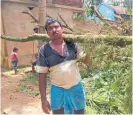  ?? Photo / AP ?? A villager clears tree branches after Cyclone Amphan hit his village in West Bengal state, India.