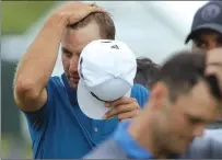  ?? Associated Press ?? World No. 1 Dustin Johnson wipes his head as he walks off the 18th green during the second round of the U.S. Open on Friday at Erin Hills in Erin, Wis.