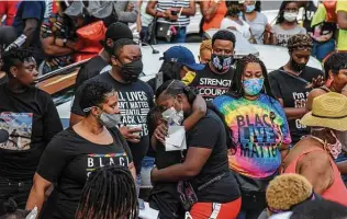  ?? Washington Post file photo ?? A friend of Davon McNeal is comforted as a crowd gathers in July for a celebratio­n of the life of the 11-year-old sixth-grader, who was fatally shot by a stray bullet in Washington, D.C.