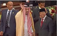  ?? - AFP File ?? ELATED: Saudi Arabia’s King Salman bin Abdulaziz Al Saud, second left, waves next to parliament speaker Setyo Novanto, front right, at the parliament in Jakarta on March 2, 2017.