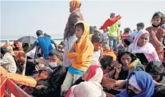  ?? REUTERS ?? Rohingya refugees sit on wooden benches of a navy vessel on their way to the Bhasan Char island in Noakhali district, Bangladesh in December last year.