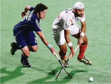  ??  ?? Top scorer: India’s Sandeep Singh (right) fighting for the ball with France’s Simon Martin Brisac during the hockey Olympic qualificat­ion final in New Delhi, India, in February. Sandeep scored 16 goals in the tournament. — EPA