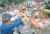  ?? PTI ?? Police personnel in a scuffle with activists of the J&K People’s Democratic Party in Jammu on Tuesday.