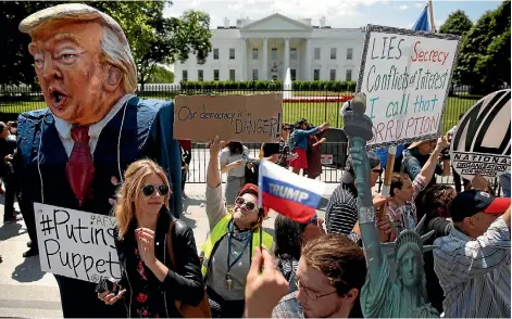  ?? PHOTO: REUTERS ?? Protesters gather to rally against US President Donald Trump’s firing of FBI director James Comey, outside the White House in Washington.