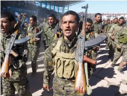  ?? (Reuters) ?? SYRIAN DEMOCRATIC FORCES (SDF) celebrate the first anniversar­y of Raqqa province’s liberation from ISIS last week. Was the celebratio­n premature?