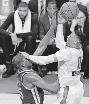  ?? [PHOTO BY BRYAN TERRY, THE OKLAHOMAN] ?? Oklahoma City’s Russell Westbrook, right, uses his hand to elevate over Golden State’s Kevin Durant, but Durant was called for a foul.