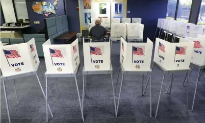  ?? Photograph: Joe Burbank/AP ?? A voter casts his ballot in Florida. Felons are currently barred from voting until they have paid all their legal fees.