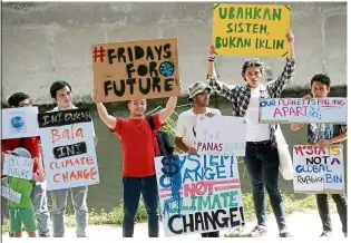  ??  ?? Making their voices heard: Protesters holding placards during the Fridays for Future climate change assembly at the Damai LRT station in Taman Keramat.