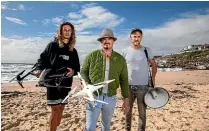  ?? FAIRFAX ?? ‘‘A potential attack that we saved’’: Carl Ellis, left, Josh Marx, centre, and Jason Iggleden from Drone Shark at Tamarama Beach.