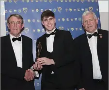  ??  ?? Donal O’Sullivan accepting the Under-20 Footballer of the Year award from Liam Lenihan, Munster GAA Vice-Chairman, and Munster Chairman Jerry O’Sullivan