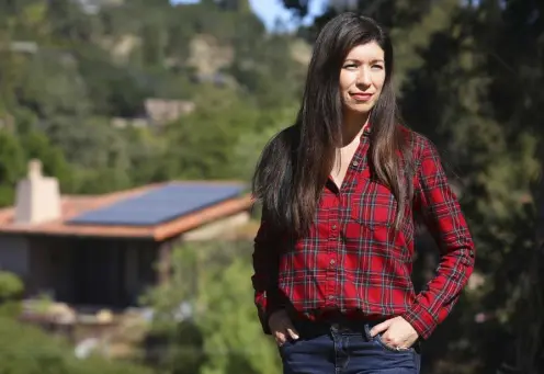 ?? Photos by Jim Wilson, © The New York Times Co. ?? Theresa Garcia stands near her home and its solar panels, which she cannot use until a nearby transforme­r is upgraded, in Portola Valley, Calif., on Oct. 14.