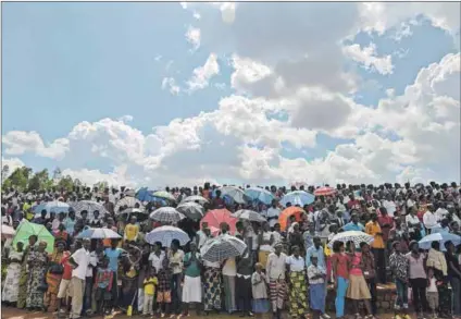  ??  ?? Guiding light: A crowd watches the passing of the Kwibuka Flame of Remembranc­e in Kigali, Rwanda, as part of a national mourning period for those killed during the genocide in 1994. Photo: Simon Maina/AFP