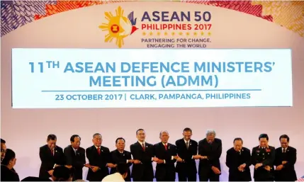  ?? Shane F. Velasco/PIA 3 ?? UNITY. Defense ministers lock arms during the opening of the 11th Asean Defense Ministers’Meeting in Clark Freeport on Monday.—