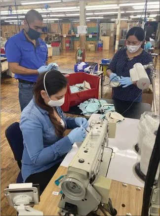  ?? COURTESY OF ISOLATOR FITNESS ?? Employees at Isolator Fitness assemble cloth masks, which are available for free plus the cost of shipping and handling on the Reading company’s website, isomask.net.