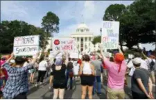  ?? BUTCH DILL — THE ASSOCIATED PRESS ?? Protesters for women’s rights hold a rally on the Alabama Capitol steps to protest a law passed last week making abortion a felony in nearly all cases with no exceptions for cases of rape or incest, Sunday in Montgomery, Ala.