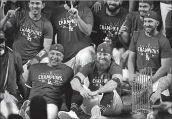  ?? ERIC GAY/AP PHOTO ?? Dodgers manager Dave Roberts and third baseman Justin Turner, bottom row, pose for a group picture after they defeated Tampa Bay on Tuesday night, 3-1, to win the World Series in Arlington, Texas.