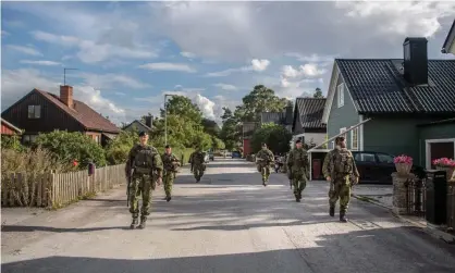  ??  ?? Swedish armed forces patrolling a village in Gotland as part of a show of force in the Baltic Sea region amid concern about Russian incursions. Photograph: Bezhav Mahmoud/AFP/Getty