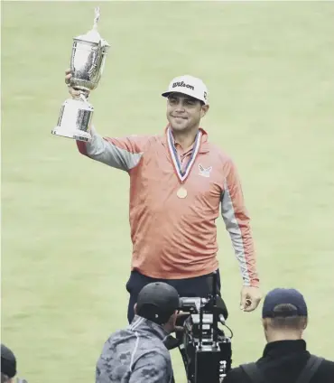  ??  ?? 0 Gary Woodland poses with the US Open trophy following his three-shot victory on Sunday.