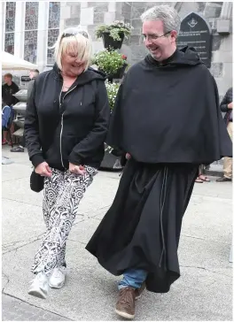  ??  ?? Geraldine Simpson and Fr. Colm O’Mahony enjoying the tunes on Shop Street.