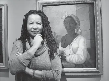  ?? MARIE-FRANCE COALLIER/ THE GAZETTE ?? McGill University Professor Charmaine Nelson is seen at the Museum of Fine Arts with a portrait painted in 1786 by François Malépart de Beaucourt. The woman is believed to have been brought to Montreal by Beaucourt as his slave.