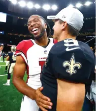  ?? Butch Dill/Associated Press ?? ■ Arizona Cardinals wide receiver Larry Fitzgerald laughs with New Orleans Saints quarterbac­k Drew Brees (9) in the second half of an NFL preseason football game Friday in New Orleans.