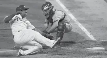  ?? MATT SLOCUM/THE ASSOCIATED PRESS ?? Jays catcher Josh Thole, right, slaps the tag on Philadelph­ia’s Marlon Byrd as he tries to score in the sixth inning.