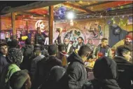  ?? AP photo ?? Palestinia­ns buy food for a pre-dawn meal before fasting during the Muslim holy month of Ramadan in Rafah, Gaza Strip on Sunday.