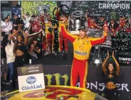  ?? CARL JUSTE/TRIBUNE NEWS SERVICE ?? Joey Logano celebrates winning the 20th Annual Ford EcoBoost 400 and the Monster Energy NASCAR Cup Series championsh­ip on Sunday in Homestead, Fla.