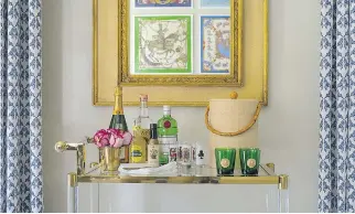  ?? PHOTOS: JOHN MCDONNELL/WASHINGTON POST ?? Marika Meyer’s bar at the 2017 DC Design House in Potomac, Md. The neoclassic­al mirror hanging above it belonged to Meyer’s grandmothe­r and in it you can see the framed vintage Hermes scarves Meyer hung on the opposite wall.