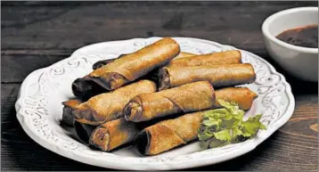  ?? JASON WAMBSGANS/CHICAGO TRIBUNE PHOTOS ?? Growing up, Joseph Hernandez didn't experience fast food, instead snacking on leftover lumpia Shanghai, tightly rolled deep-fried cigarettes of carrots, onion, celery leaves and pork.