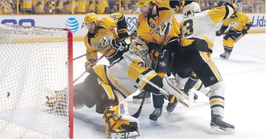  ?? JUSTIN K. ALLER/GETTY IMAGES ?? Nashville Predators forward Calle Jarnkrok scores a goal against Pittsburgh Penguins goalie Matt Murray during the first period Monday in Nashville, Tenn.