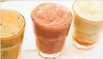  ?? MELISSA D’ARABIAN VIA AP ?? Glasses of icy agua fresca. 1 cup frozen seedless watermelon cubes (about 1 inch each) 1 cup strawberri­es, stemmed and halved (or other summer fruit, like mango or cantaloupe cubes) 1 cup ice-cold water 1 cup ice cubes ¼ cup freshly squeezed orange...