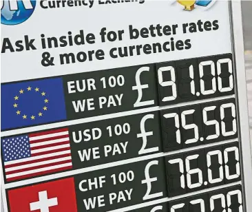  ??  ?? Money rules: A board displaying the price of euro and US dollars against British pound sterling outside a currency exchange store in central London. New European Union regulation­s on foreign exchange trading will make it harder and more expensive to...