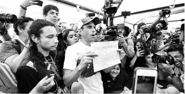 ??  ?? Venezuelan opposition leader and Miranda State governor Henrique Capriles signs the form to activate the referendum on cutting Maduro’s term short, in Caracas. — AFP photo