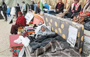  ?? — AP ?? Climate fast: Wangchuk, lying under blankets, surrounded by supporters during his hunger strike, seeking protected status for the region’s people, land and ecology in Leh.