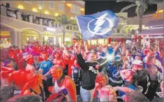  ?? Luis Santana Associated Press ?? FANS CHEER in Tampa, Fla., after the Lightning’s 2-0 victory over the Rangers in New York in Game 7 of the Eastern Conference finals.