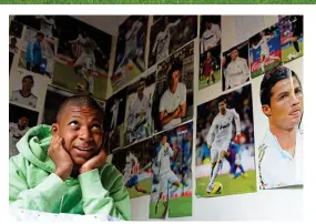  ?? L’EQUIPE ?? Dreams of stardom: a 14-year-old Mbappe at home in Paris with posters of Cristiano Ronaldo on his bedroom walls