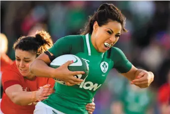  ?? DAVID FITZGERALD/SPORTSFILE ?? Sene Naoupu breaks the tackle from Wales’ Rhiannon Parker as she runs in to score Ireland’s third try at Donnybrook yesterday