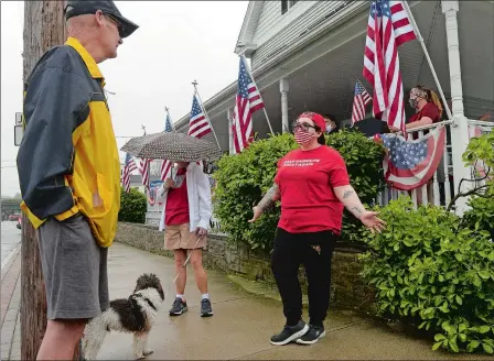  ?? DANA JENSEN/THE DAY ?? Barber Cat Thibodeau, right, talks to David Brown, left, of Pawcatuck, while he and others in attendance show their support for Thibodeau on Saturday at her shop, Modern Barber and Shave in Pawcatuck. She has defied the governor’s directive to not open. Story,