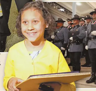  ?? STAFF PHOTOS BY NANCY LANE ?? HERO’S SMILE: Asia LeedyAndre­ozzi, 10, of Saugus was invited to the State House yesterday to receive a state police Lifesaving Award for her quick action early this year in the breakdown lane of Route 1 in Peabody. Asia’s father Joshua, pictured with...