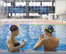  ?? AP photo ?? Ukrainian sisters Maryna, (left) and Vladyslava Aleksiiva speak during a pactice session in Kyiv, Ukraine, on Feb. 21. The path to the 2024 Paris Olympics for Ukrainian athletes is clouded by war, anger and pain. Russian bombardmen­ts have wrecked training venues, air raids disrupt training sessions. Athletes have lost family members and friends or they worry that they will.