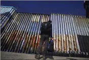  ?? MARCO UGARTE — THE ASSOCIATED PRESS FILE ?? A migrant waits of the Mexican side of the border after United States Customs and Border Protection officers detained a couple of migrants crossing the US-Mexico border on the beach, in Tijuana, Mexico.