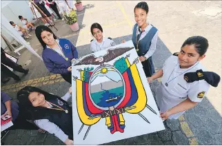  ?? CHRISTIAN VINUEZA / EXPRESO ?? Acción. La pintura que cargan las jóvenes es parte de uno de los trabajos artísticos en homenaje al emblema.