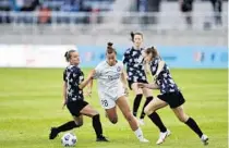  ?? COURTESY ORLANDO PRIDE ?? Orlando Pride midfielder Meggie Dougherty Howard cuts between a pair of Racing Louisville defenders during the team’s season opener at Lynn Family Stadium.