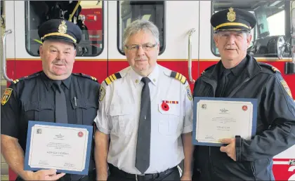  ?? SAM MCNEISH/THE TELEGRAM ?? The Department of Municipal Affairs and Environmen­t and the office of the Fire Commission­er for Newfoundla­nd and Labrador honoured Fire Capt. Gerry O’neill and Fire Capt. Craig Cox in recognitio­n and appreciati­on of 25 years of Internatio­nal Fire...