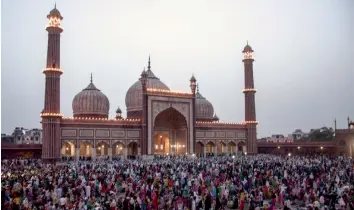  ?? PTI ?? People gather in front of Jama Masjid in Delhi on Sunday during Ramzan.