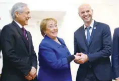  ?? — Reuters ?? Chile’s President Michelle Bachelet and Argentina’s Transport Minister Guillermo Dietrich (R) shake hands next to Chilean Minister of Foreign Affairs, Heraldo Munoz at the government house in Santiago, Chile, recently.